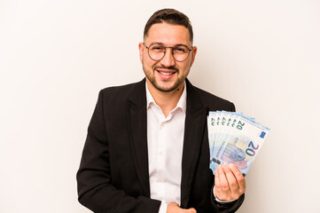 Business hispanic man holding banknotes isolated on white background laughing and having fun.