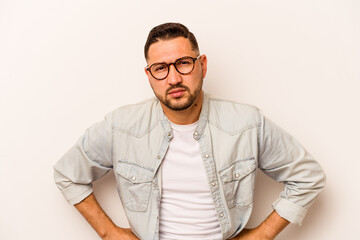Fototapeta premium Young hispanic man isolated on white background sad, serious face, feeling miserable and displeased.
