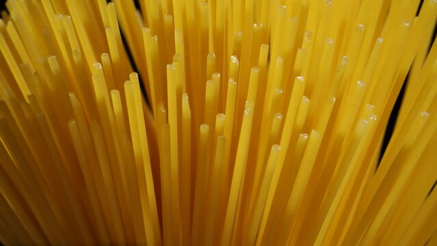 Macro shot of spaghetti rotating on black background. 4k footage
