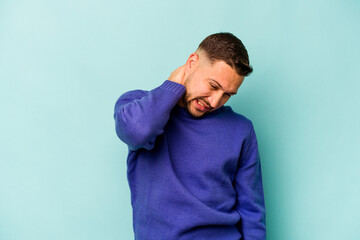 Young hispanic man isolated on blue background suffering neck pain due to sedentary lifestyle.