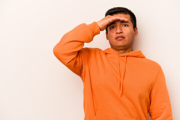 Young hispanic man isolated on white background looking far away keeping hand on forehead.