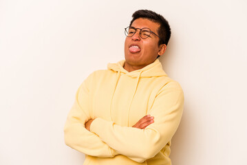 Young hispanic man isolated on white background funny and friendly sticking out tongue.