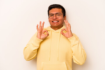 Young hispanic man isolated on white background cheerful and confident showing ok gesture.