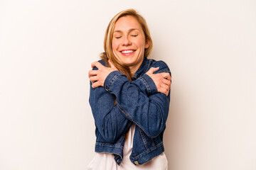 Young caucasian woman isolated on white background hugs, smiling carefree and happy.