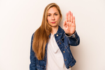 Young caucasian woman isolated on white background standing with outstretched hand showing stop...