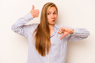 Young caucasian woman isolated on white background showing thumbs up and thumbs down, difficult...