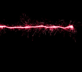 Fototapeta na wymiar red sparks in the dark, lines of glowing sparks
