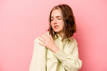 Young caucasian woman isolated on pink background having a shoulder pain.