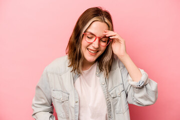 Young caucasian woman isolated on pink background joyful laughing a lot. Happiness concept.