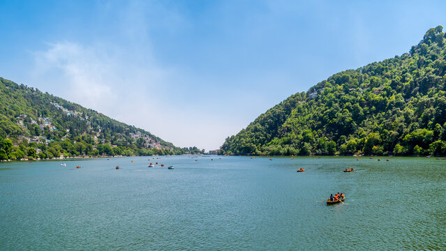 View of Nainital Lake from lakefront and mountains are in the background