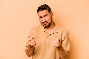Young hispanic man isolated on beige background showing that she has no money.