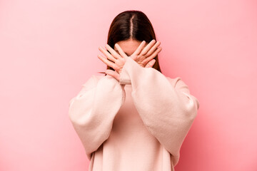 Young caucasian woman isolated on pink background keeping two arms crossed, denial concept.