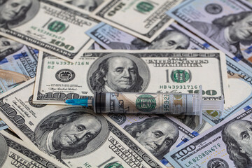 Fototapeta premium Syringe with 100 dollar banknote inside