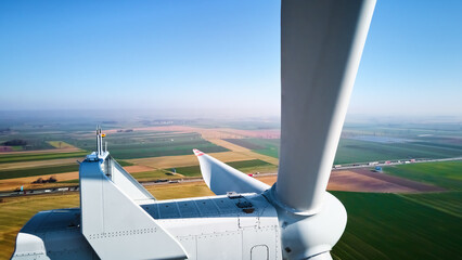 Aerial view of close up windmill turbine in countryside area, Wind power and renewable sustainable energy concept