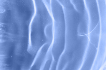 Blue textured background of waves on the water