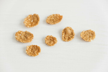 Crispy healthy dry cereal flakes on white background