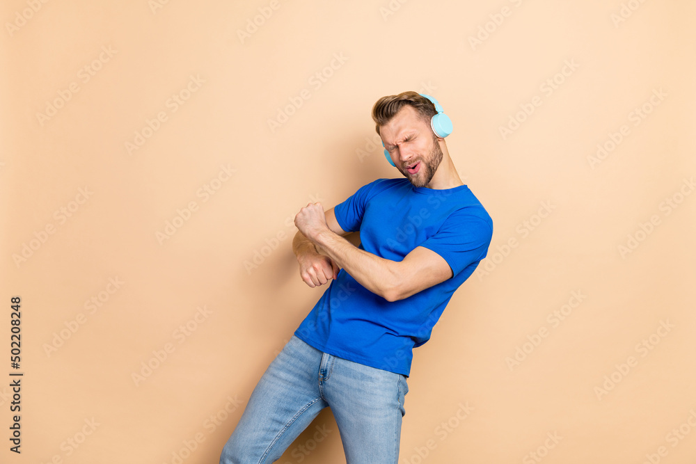 Sticker Photo of young excited man good mood clubber chill sound mp3 hang-out isolated over beige color background