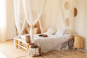 Cozy scandinavian decoration room. hygge decor at home. interior white bedroom in boho style with...