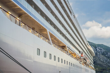 Cruise ship at harbor. Beautiful large white ship at sunset. Colorful landscape with boats in...