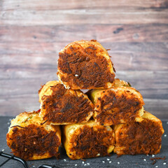 Indonesian snack, Roti gulung abon ikan tuna or Shredded tuna roll on a white folding plate.