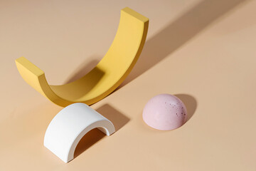 Geometric concrete figure and stones on pastel background. Modern set from various materials and geometric shapes.