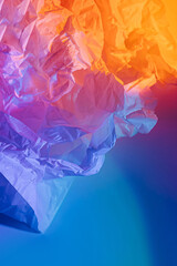 Abstract background with crumpled paper in neon gradient. Vivid blue, pink and orange colors