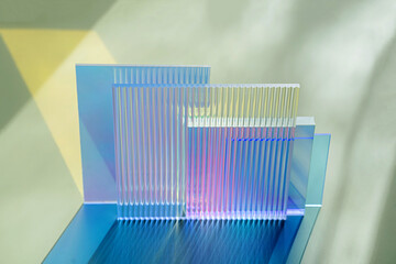 Ribbed and multicolored glass on a green background. The light travels through different acrylic...