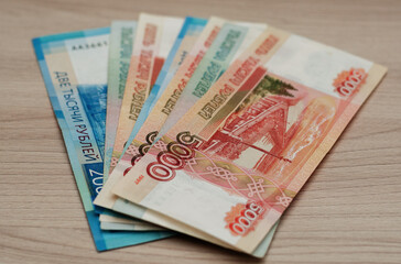 Russian Ruble money banknotes on a wooden desk - financial, loan and investment concepts.
Horizontal view.