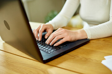 Close up female hands searching on laptop, woman working online, checking email, social network, using computer apps