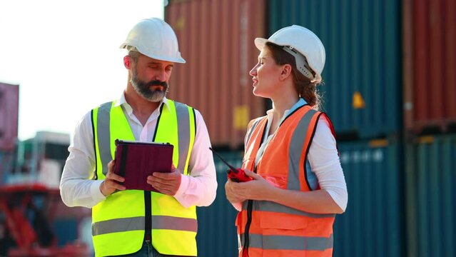 Customs man and women dock manager control loading Containers box from Cargo at container yard. Import and Export concept. Marine, carrier and logistic insurance