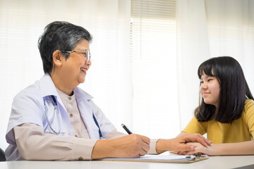 Depressed asian girl having consultation with psychologist at clinic.