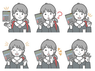 電卓を手に持つ小学生女子