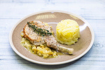 pork chop with thyme baked on creamy onion with mashed potatoes