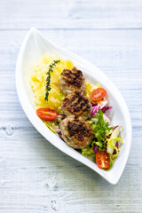 minced veal steaks with mashed potatoes and salad