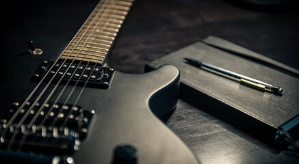 Fototapeta na wymiar Close-up, electric guitar and notepad, concept of musical creativity.