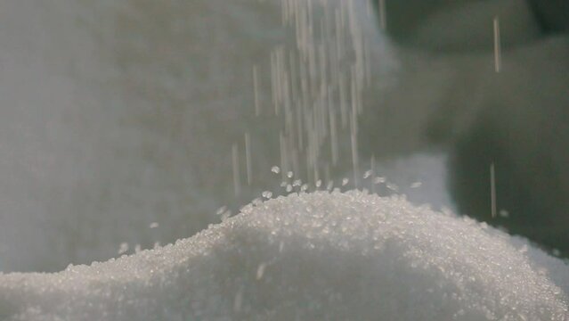Falling polypropylene granules, slow motion. Polypropylene granules. Polypropylene granules close-up. Nonwoven Fabric Factory
