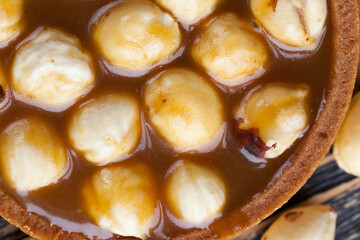 delicious tartlet cake with soft caramel and roasted hazelnut