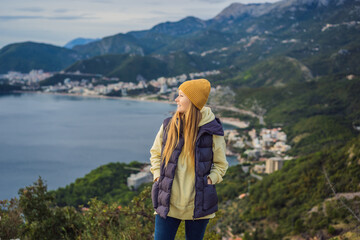 Woman in the mountains of Montenegro in warm clothes. Travel to Montenegro in spring, autumn, winter