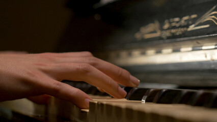 A young woman playing piano closeup. Piano hands pianist playing Musical instruments details with player hand closeup