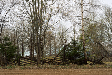 Fototapeta premium broken fence in the cultural landscape of Biri, Oppland, Norway, in spring