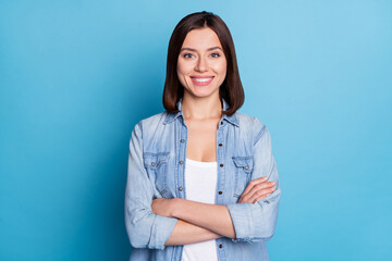 Photo of sweet confident woman wear jeans shirt smiling arms crossed isolated blue color background