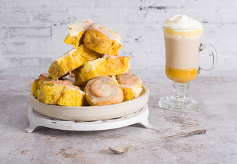 pumpkin cinnabons and latte for dessert, holiday table with pastries, home sweet