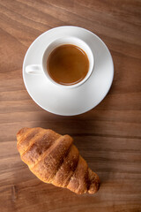 Croissant with espresso in white cup,top view	