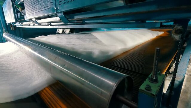 Syntepon manufacturing process. How synthpeon is made. Factory of nonwoven materials. Inside the machine for the production of synthetic winterizer