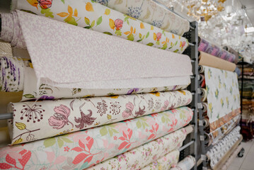 Samples of different wallpapers on store window racks