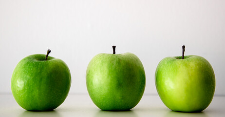Green apples on a white background close-up.