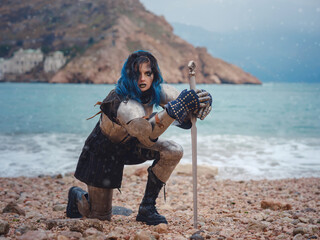 Medieval knight woman in armor prays, blessing before the battle.