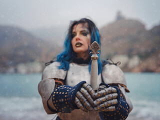 Medieval knight woman in armor prays, blessing before the battle.