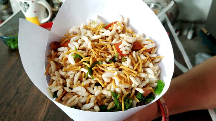 Bhel poori, an Indian road side snack in a conical shape paper container