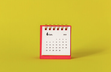 Desktop mini calendar for June 2022 on a yellow background.